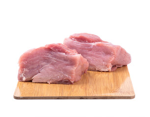 Pieces of fresh juicy pork meat on cutting board over white background.
