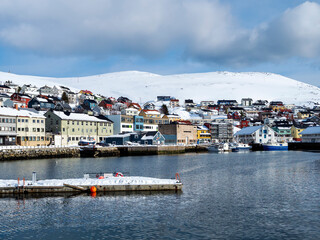Fototapeta premium Honningsvag, Norway, in winter with snowcapped mountains