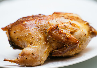 Fried quail on a white plate.