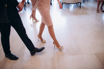 legs of bridesmaids in elegant evening dresses at a bachelorette party