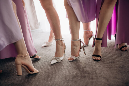 legs of bridesmaids in elegant evening dresses at a bachelorette party