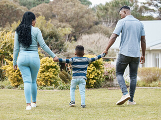 Fototapeta premium Family is everything. Full length shot of an unrecognisable couple bonding with their son in the garden.