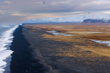Fototapeta na wymiar The endless black sand beach at Derholaye on the south coast of Iceland