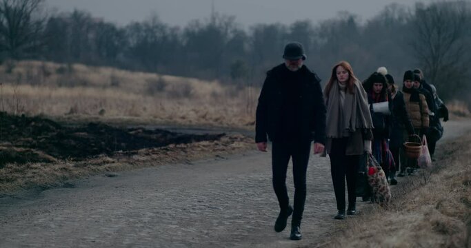 War Immigrants With Luggage Walking On Road.