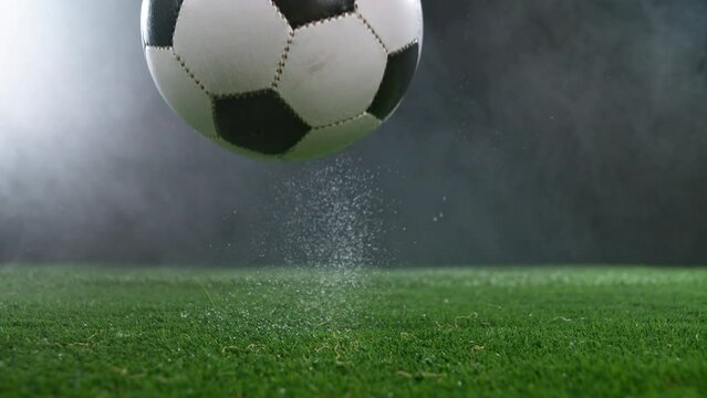 Close-up of Falling Soccer Ball on Football Field, Super Slow Motion at 1000 fps. Filmed on High Speed Cinematic Camera.