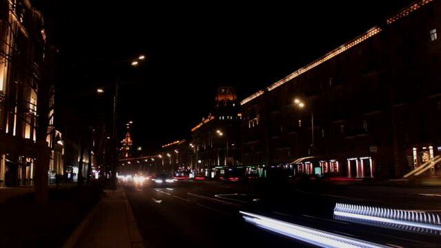 Moscow, Russia, Mar 3, 2022: Night traffic at Bolshaya Sadovaya street (Garden ring). Old empire style house built in 1930s. Timelapse