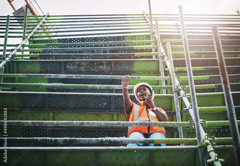 Aufkleber planning, organising and directing the completion of a new site. shot of a young woman using a walki
