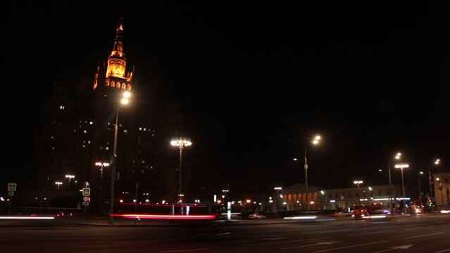 Moscow, Russia, Mar 3, 2022: Night view of Kudrinskaya square. Old soviet skyscraper. Traffic, Car traces. Timelapse