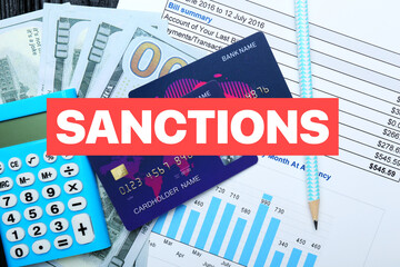 Credit cards with calculator, money and document on table. Sanctions concept