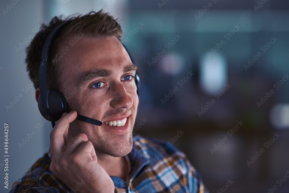 Poster service with a smile. shot of a happy customer service agent wearing a headset while sitting in the 