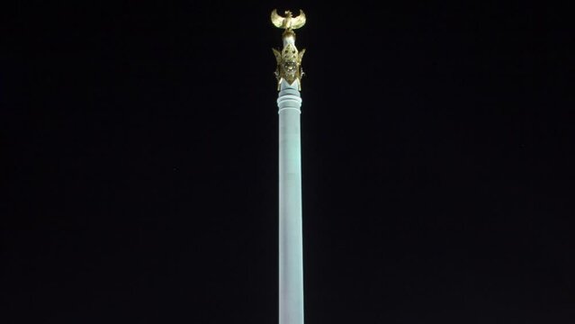 Stele monument Kazakh Eli with bird Samruk and Palace of Independence timelapse hyperlapse at night.