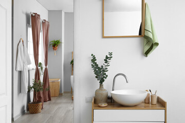 Modern sink, towel and mirror in bathroom