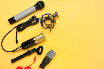New modern microphones on color background