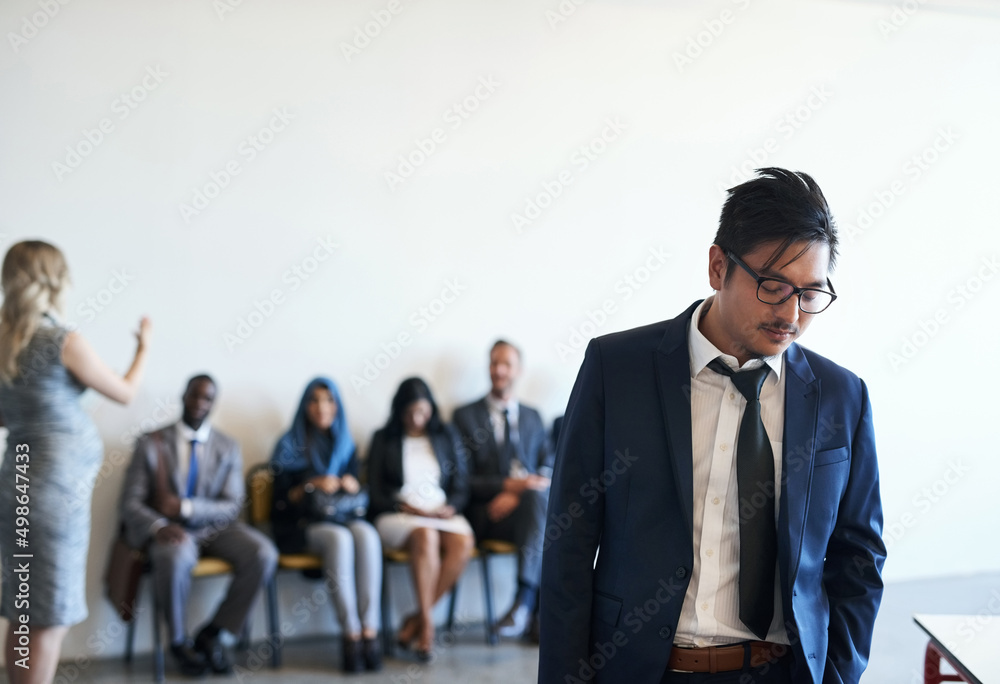 Poster today was not his day. shot of a dejected job applicant leaving the waiting room after his interview