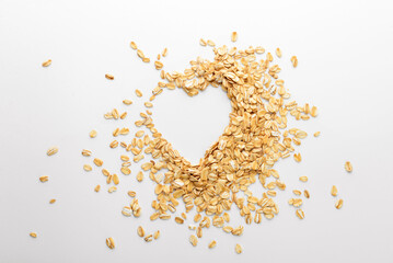 Heart shape made of oat flakes on white background