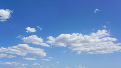 blue sky with white clouds on sunny day, suitable for background or sky substitution