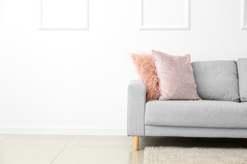 Modern sofa near white wall