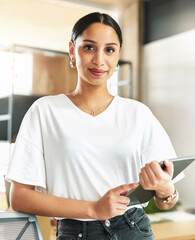Hard work is what has made me a pro. Shop of a young businesswoman holding a digital tablet at work.
