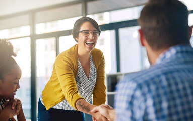Were so glad that youll be joining our team. Cropped shot of businesspeople shaking hands in an...