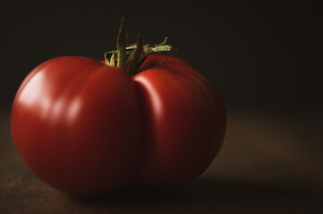 close up of red tomato on a dark background