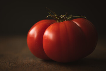 close up of red tomato on a dark background