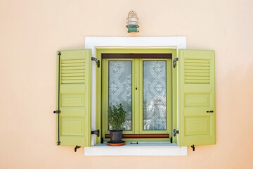Cute vintage window with green shutters