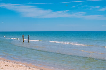 Two wooden pillars for boat in the calm sea