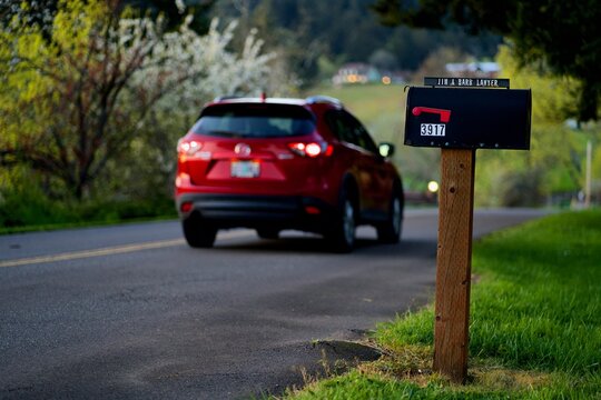 Mailbox With In Car In Background On The Road