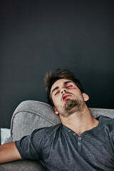 Beaten and broken. Cropped shot of a beaten and bruised young man sleeping on the sofa.