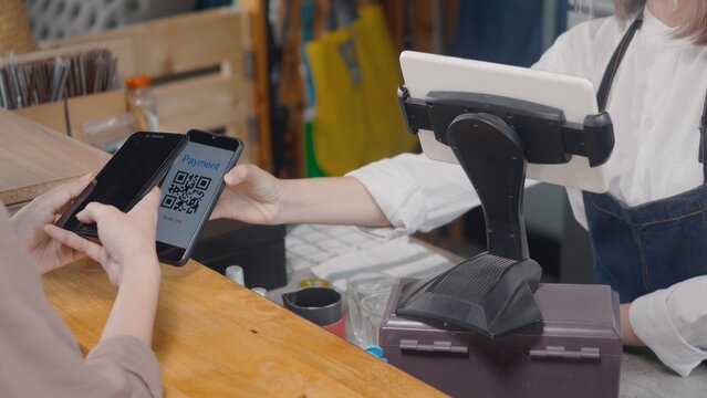 QR code payment, customer woman using digital smartphone application scanning QR code payment without money for buying coffee in cafe coffee shop, small business accepts digital payment