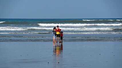 Family on the beach in Canoa, Ecuador