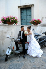 bride and groom with a vespa 