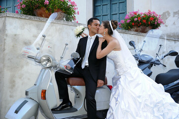 bride and groom with a vespa 