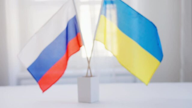 Representatives of Ukraine and Russia shaking hands, Ukraine peace agreement concept.
