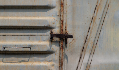 Metal lock at Vintage railroad container doors gates in old station. Doors of old railroad bogie or old train carriages. Copy spce, Selective focus.