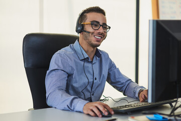 Ill take a look at the issue from my end. Shot of a young call centre agent working in an office.