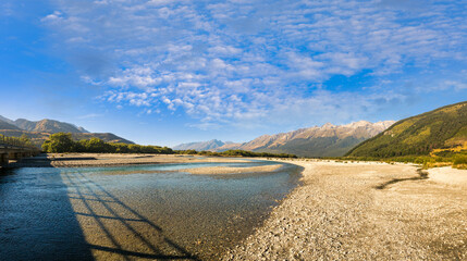 The beautiful clear blue aqua water in the Rees river close to Glenorchy heading for Lake Sylvan