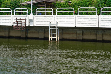 White wall along the Saen Saep Canal, Bangkok, Thailand, must have stairs for going up and down,...