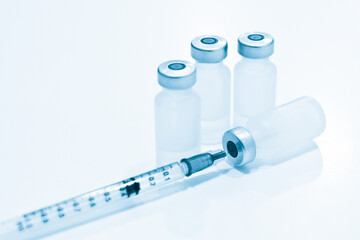 Vial of Drugs and 1 ml Plastic Syringe with Needle Isolated on the White Background