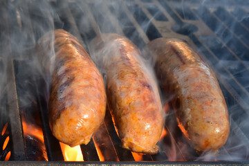 Flame-grilling spicy Italian sausages