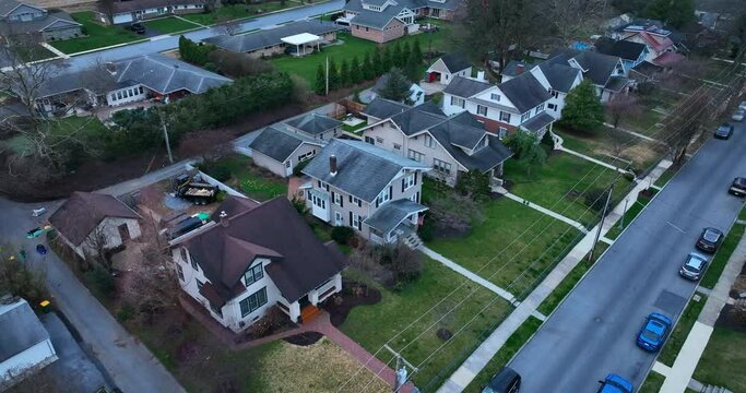 Aerial of homes in USA at night. Evening shot of houses along residential district street. Hershey Pennsylvania.