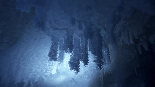 Crystal icicles, sharp ice stalactites, frozen grotto blue ice and snowflakes