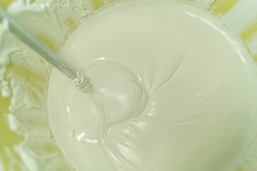 White putty in a bucket of water. Preparation of mortar for finishing walls and ceilings in the apartment. Repair in the house. DIY. Selective focus