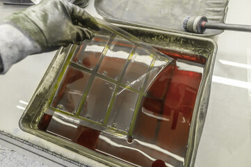 The process of manual washing of polymer printing plates in a special solution dissolving the...