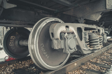Wheel pairs of a freight railway car. Wheeled trolley of a train car. Steel wheels on rails of the...