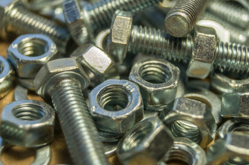 Various hardware. Metal fasteners. Bolts, nuts and washers. Soft focus, abstract, industrial background