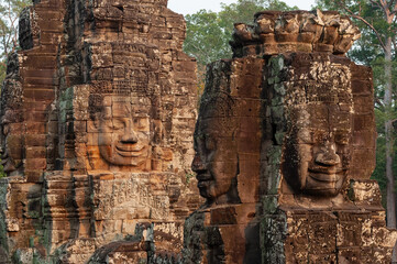 Buddha faces in traditional khmer architecture at sunset, Bayon temple, Angkor, Cambodia.