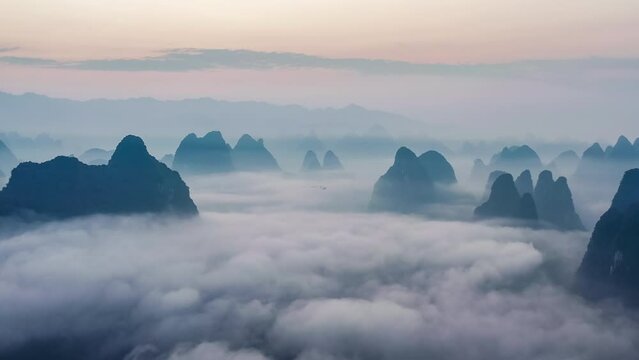 Aerial footage of beautiful mountain and clouds with fog natural landscape in Guilin at sunrise, China. famous tourist destination in china.