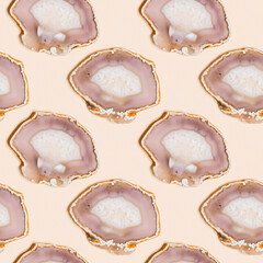 Seamless pattern of agate crystals on pastel beige background,  top view natural slices beautiful gemstone as abstract flat lay. Agate stone healing crystal, minimal style monochrome color