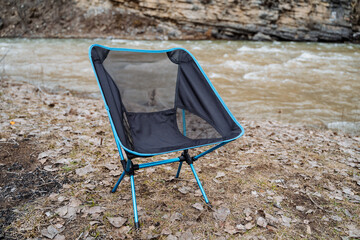 Folding chair for outdoor recreation, camp equipment, compact folding chair. - obrazy, fototapety, plakaty